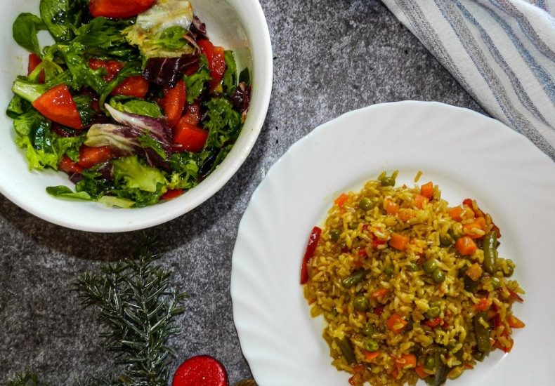 Vibrant healthy salad and vegetable rice on a table, perfect for a nutritious meal.